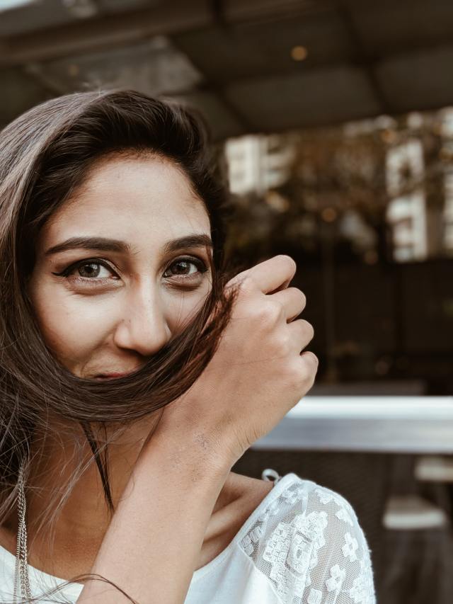 Woman with hair in front of mouth