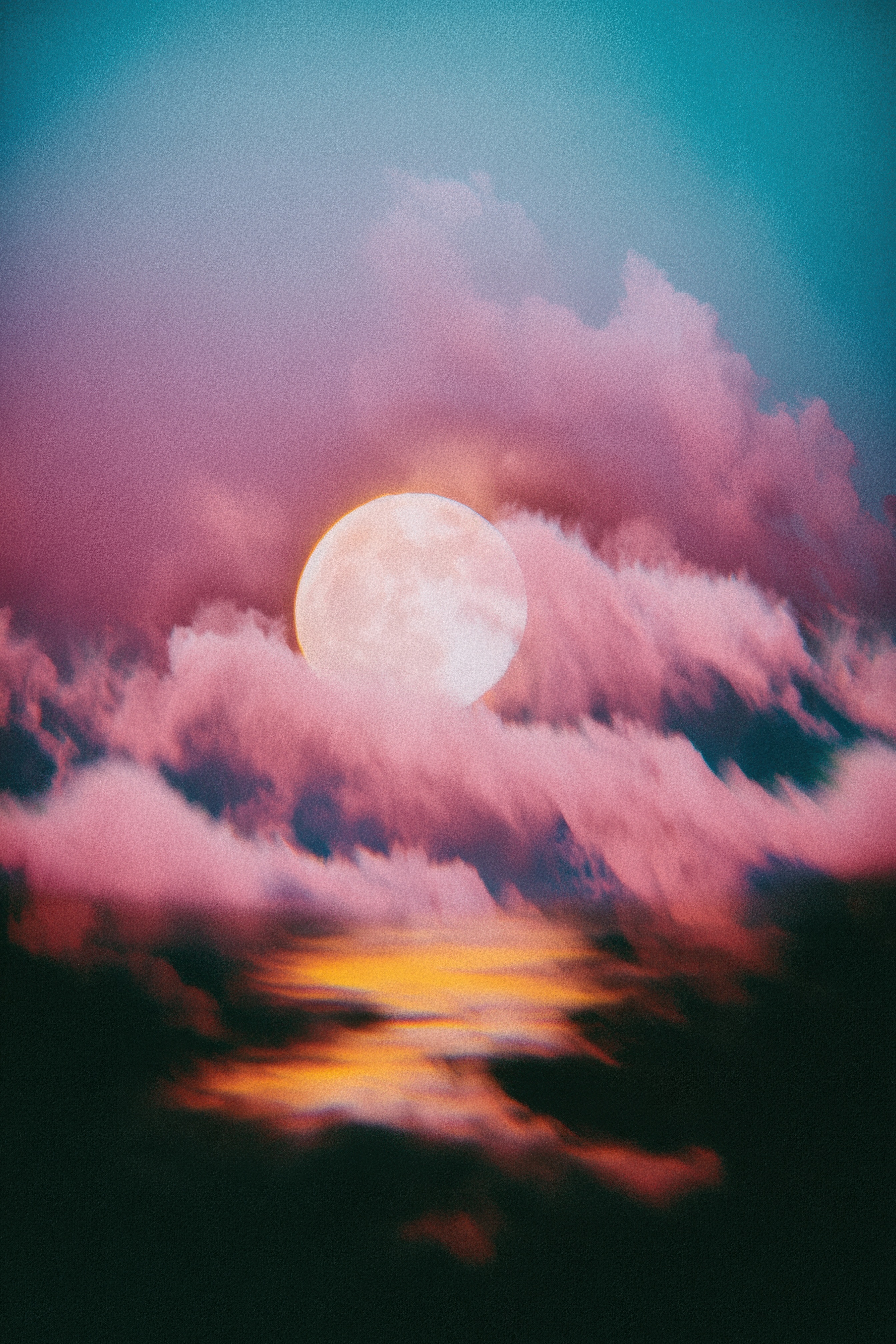 Full moon glowing between layers of soft pink clouds in a surreal teal and magenta night sky with golden light at the base.