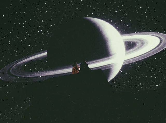 Two silhouetted people facing each other in front of a large glowing image of Saturn with rings and a starry background.